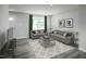 Inviting living room with neutral tones, comfortable sofas, and a stylish geometric patterned rug at 221 N Coral Bells Way, Four Oaks, NC 27524