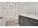 Clean bathroom featuring a shower-tub combo and a modern vanity with great storage at 2212 Edwin Ave # A, Durham, NC 27705