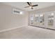 Large carpeted bedroom with french doors leading to a balcony and lots of natural light at 2212 Edwin Ave # A, Durham, NC 27705