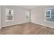 Bright bedroom with hardwood floors and three windows for ample natural light at 2212 Edwin Ave # A, Durham, NC 27705
