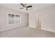 Well-lit bedroom featuring plush carpet, a ceiling fan, and a view of the outdoors through a window at 2212 Edwin Ave # A, Durham, NC 27705