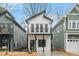 Charming two-story new home with a balcony and modern design elements, framed by neighboring houses at 2212 Edwin Ave # A, Durham, NC 27705