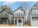 Charming two-story new home with a balcony and modern design elements, framed by neighboring houses at 2212 Edwin Ave # A, Durham, NC 27705