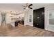 Spacious living room featuring sleek wood floors, a modern ceiling fan, and an open layout to the kitchen at 2212 Edwin Ave # A, Durham, NC 27705
