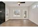 Bright living room featuring wood floors, a ceiling fan, and natural light from many windows at 2212 Edwin Ave # A, Durham, NC 27705