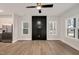 Spacious living room with wood floors, a modern ceiling fan, and a black storage cabinet at 2212 Edwin Ave # A, Durham, NC 27705