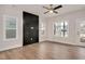Bright, neutral living room with wood floors, a ceiling fan, ample windows, and a storage cabinet at 2212 Edwin Ave # A, Durham, NC 27705