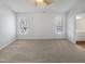 Bright, carpeted bedroom featuring two windows and an ensuite bathroom at 23 Round Spring Ln, Durham, NC 27712