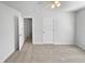 Carpeted bedroom featuring white walls and a ceiling fan at 23 Round Spring Ln, Durham, NC 27712