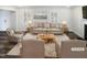 Bright living room featuring neutral furniture, stylish decor, and ample natural light streaming through the windows at 23 Round Spring Ln, Durham, NC 27712