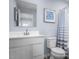 Clean bathroom featuring a white sink, toilet, and mirror at 231 N Coral Bells Way, Four Oaks, NC 27524