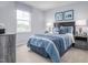 Relaxing bedroom featuring cool blues, soft bedding, and modern décor at 231 N Coral Bells Way, Four Oaks, NC 27524