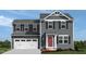 Charming two-story home featuring a two-car garage, gray siding, black shutters, and a red front door at 231 N Coral Bells Way, Four Oaks, NC 27524