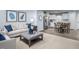 Inviting living space with plush seating, stylish décor, and an adjacent kitchen area with modern appliances at 231 N Coral Bells Way, Four Oaks, NC 27524