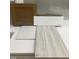 Bathroom remodel sample featuring a wooden cabinet, floor tiles, and a stone countertop at 25 Bold Dr, Youngsville, NC 27596