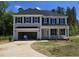 Charming two-story home featuring black shutters, an open garage, and a well manicured lawn at 25 Bold Dr, Youngsville, NC 27596