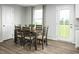Cozy dining room featuring a wooden table with seating for six and a view of the backyard at 254 N Coral Bells Way, Four Oaks, NC 27524