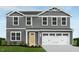Charming two-story home featuring a gray exterior, a two-car garage, and a well-manicured lawn at 254 N Coral Bells Way, Four Oaks, NC 27524