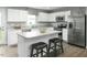 Modern kitchen with white cabinetry, stainless steel appliances, and a central island with bar seating at 254 N Coral Bells Way, Four Oaks, NC 27524