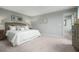 Spacious main bedroom featuring soft carpet, neutral tones, and elegant furnishings at 254 N Coral Bells Way, Four Oaks, NC 27524