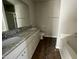 Bathroom features a double vanity with granite counters, wood floors, and a separate soaking tub at 26 Harvest Hills Ln, Dunn, NC 28334
