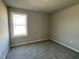 Bedroom features a window allowing natural light and comfortable carpeting at 26 Harvest Hills Ln, Dunn, NC 28334