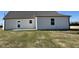 Exterior view of the home with light gray vinyl siding and a concrete back patio at 26 Harvest Hills Ln, Dunn, NC 28334