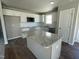 Modern kitchen with granite countertops, stainless steel appliances, and a center island at 26 Harvest Hills Ln, Dunn, NC 28334