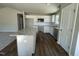 Open-concept kitchen showcases white cabinets, stainless appliances, granite countertops, and island with storage at 26 Harvest Hills Ln, Dunn, NC 28334