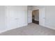 Bedroom with carpet flooring, double closet, and an open doorway at 26 Northwood Dr, Fuquay Varina, NC 27526