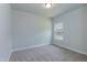 Bedroom with neutral walls, plush carpet, and a window letting in ample natural light at 26 Northwood Dr, Fuquay Varina, NC 27526