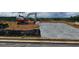 New home construction site showing foundation work and an excavator in a partially developed area at 26 Northwood Dr, Fuquay Varina, NC 27526