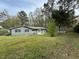 Expansive backyard with well-maintained lawn, shed, and mature tree coverage at 2616 Firelight Rd, Raleigh, NC 27610