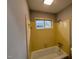 Bathroom featuring a tiled shower and tub combo with bright yellow tile at 2616 Firelight Rd, Raleigh, NC 27610