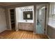 Ensuite bathroom with large mirror, vanity sink and storage, as well as toilet and walk-in closet at 2616 Firelight Rd, Raleigh, NC 27610