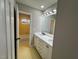 Bathroom with double vanity, white cabinets, modern lighting, and tiled floor at 2616 Firelight Rd, Raleigh, NC 27610