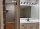 Bathroom showing a large mirror, vanity, and entrance to the bedroom with walk-in closet at 2616 Firelight Rd, Raleigh, NC 27610
