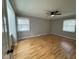 Spacious bedroom with hardwood floors, ceiling fan, neutral paint, and bright, natural light at 2616 Firelight Rd, Raleigh, NC 27610
