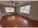 Spacious bedroom featuring hardwood floors and two large windows for natural light at 2616 Firelight Rd, Raleigh, NC 27610