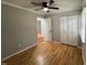 Bedroom featuring hardwood floors, neutral walls, closet, and ceiling fan at 2616 Firelight Rd, Raleigh, NC 27610