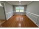 Dining room with hardwood floors, gray walls, and a large bright window at 2616 Firelight Rd, Raleigh, NC 27610