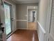 Open foyer boasts hardwood floors and white trim, offering a bright welcome into the home at 2616 Firelight Rd, Raleigh, NC 27610
