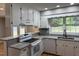 A stylish kitchen with updated countertops, white cabinetry, and modern backsplash detailing, offering function and style at 2616 Firelight Rd, Raleigh, NC 27610