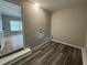 Neutral toned laundry room features modern flooring and convenient washer/dryer hookups at 2616 Firelight Rd, Raleigh, NC 27610