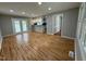 Bright living room with wood floors, open to kitchen, and sliding glass door to the outside at 2616 Firelight Rd, Raleigh, NC 27610