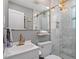 Stylish bathroom features marble tiling, glass shower, and modern gold fixtures at 2706 Mcneil St St, Raleigh, NC 27608