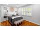 Comfortable bedroom with hardwood floors, plantation shutters, and a ceiling fan at 2706 Mcneil St St, Raleigh, NC 27608