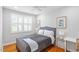 Cozy bedroom with hardwood floors, large window, and soft lighting at 2706 Mcneil St St, Raleigh, NC 27608
