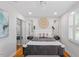 Bright bedroom featuring hardwood floors, ceiling fan, and ample natural light from the window at 2706 Mcneil St St, Raleigh, NC 27608