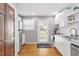 Well-lit kitchen with stainless steel appliances, white cabinetry and hardwood floors at 2706 Mcneil St St, Raleigh, NC 27608